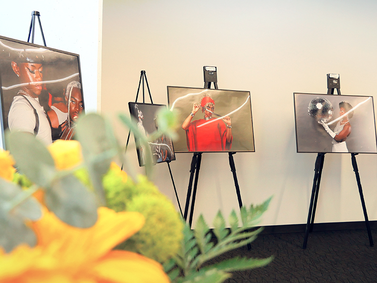 A row of framed photographs along a wall